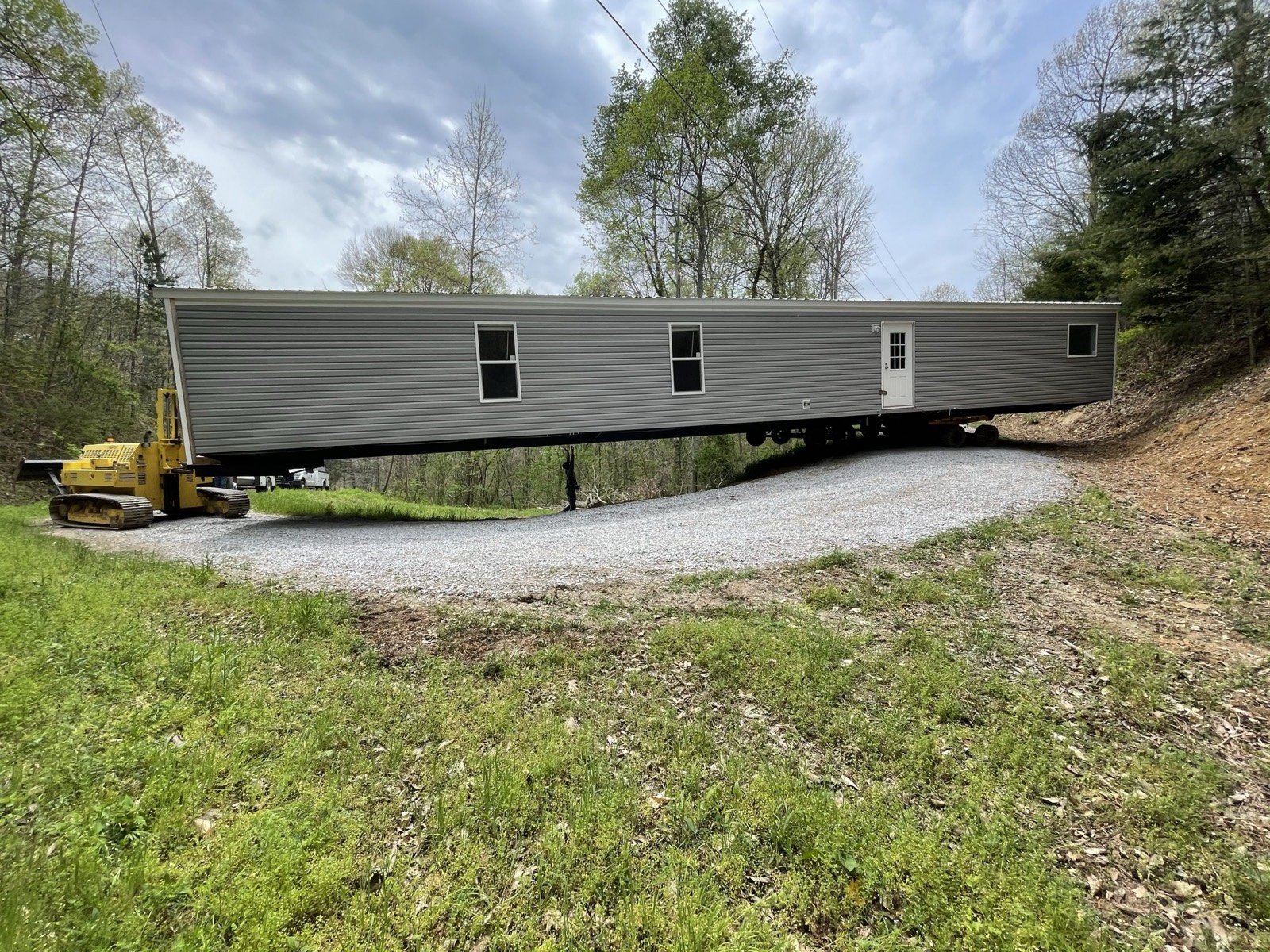 Compacted gravel building pad on a wooded lot